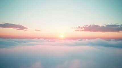 Fototapeta premium A misty, fog-filled sky with pale clouds and the soft glow of the rising sun breaking through in the distance