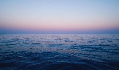 Fototapeta premium The ocean is calm and peaceful with a beautiful blue sky in the background
