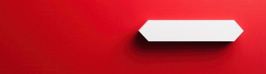 Obraz premium Minimalist design featuring white directional sign against vibrant red wall, creating striking visual contrast. simplicity evokes sense of modernity and clarity