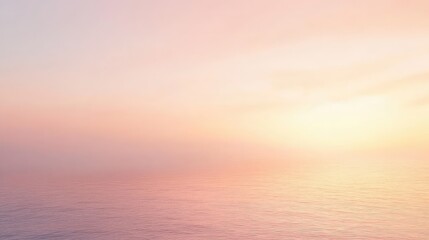 Fototapeta premium A soft hazy sky at dawn with muted orange and pink hues blending into the misty horizon, creating a tranquil and dreamy atmosphere