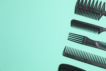 Professional combs and hairdresser tools on color background, top view