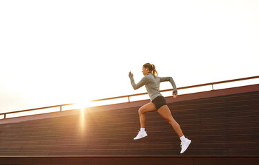 A Woman Running on a Rooftop Against a Stunning Sunset Athletic Fitness Inspiring Outdoors