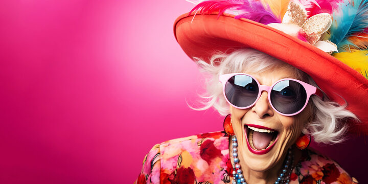 happy eccentric elderly woman in colorful clothes, hat and glasses, on multicolored background