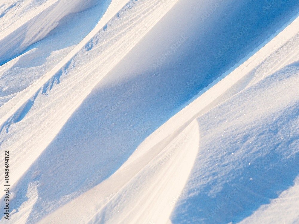 Wall mural snow texture. wind sculpted patterns on snow surface. wind in the tundra and in the mountains on the