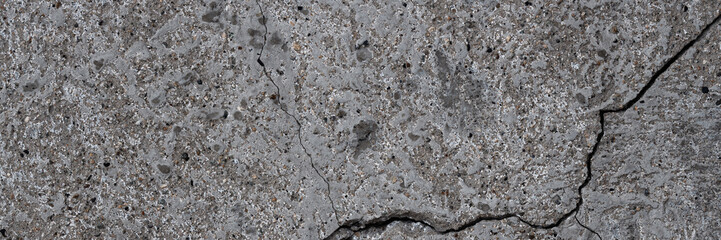 Texture of old cracked concrete wall. Rough gray concrete surface. Wide panoramic background for design.