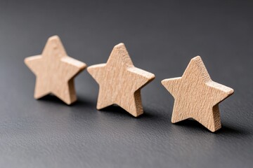 Three wooden stars on a black surface - Outdoor