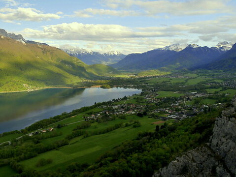 alpine landscape at the end of annecy lake on top of taillefer mountain, haute savoie in France.  Panorama photo with lake and mountains and village