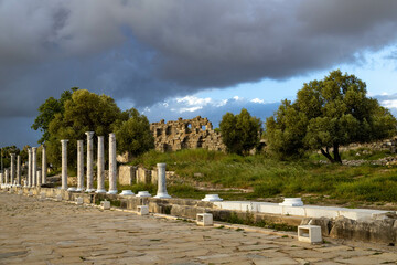 Ruins of the roman ancient street with columns  and fortress wall in Side, Antalya, Turkey