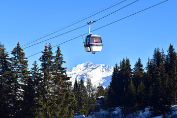Vintage Ski gondola over the slopes of Courchevel ski resort, French alps