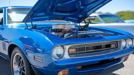 Fototapeta premium Classic American Muscle: Close-Up of a Stunning Blue Vintage Car with the Hood Open, Showcasing the Powerful Engine and Immaculate Design at a Car Show
