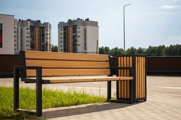 Modern residential area features benches and trash bins for enhanced outdoor enjoyment and community improvement for local residents