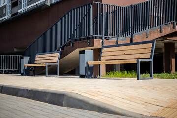 Modern residential area showcasing upgraded public space with benches for community relaxation amid...