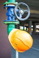 Fire hydrant and safety helmet in a modern residential complex, highlighting fire safety measures...