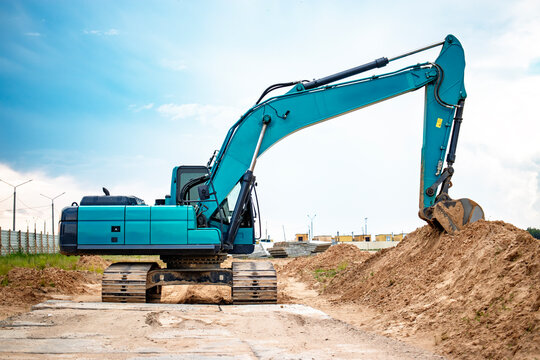 A powerful excavator at a bustling construction site, renting equipment for earthmoving tasks under a clear sky in daytime