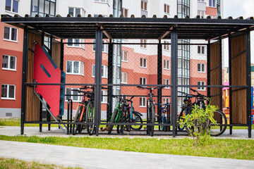 Indoor bicycle parking facility in a modern residential area designed for secure bike storage with...