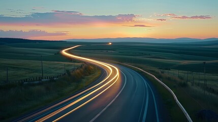 The golden hour casts a warm glow on the country road with light trails from passing cars adding a touch of modernity to the rustic charm of the countryside.