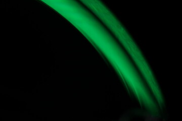 Obraz premium Green line, green smoke on a dark background, colourful abstract, green fog, minimalism, line of light