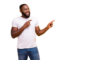 Photo of cheerful and enjoying black man pointing at nothing suspiciously staring there while...