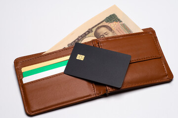 開いた財布と一万円札と黒色のクレジットカード
