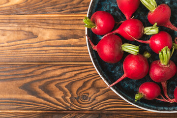 Fresh radish on textured wooden background. Organic natural garden radish slices. clipping root crop. Vegetables. Vegan. Diet products. Healthy food. Place for text. Copy space.