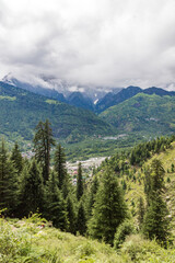 View of mountains and valleys of manali and beas river near Jogini waterfall in Himachal Pradesh India.
