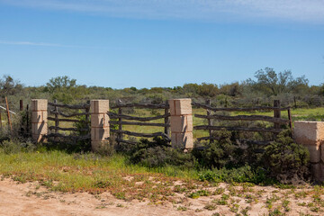 Old Rustic Wooden Fence with Stone Columns in Outback Australia. Old Australian Cattle Fencing 