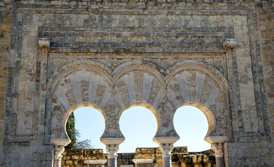 Detail of the decorative richness of the arches of the main entrance of the House of Yafar in Medina Azahara. Cordoba, Andalusia, Spain.