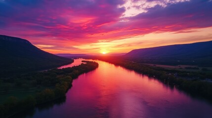 Radiant sunset over river and mountain landscape, capturing nature's tranquility and vibrant colors.