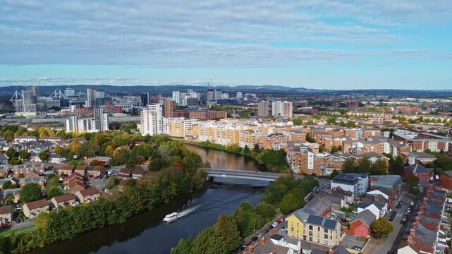 Aerial drone footage of the Grangetown district in Cardiff, Wales with River Taff running through it. Tracking right to left shot.