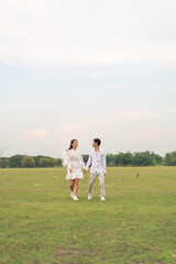 Happy young Asian couple in bride and groom clothing