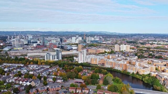 Aerial drone footage of the Grangetown district in Cardiff, Wales with River Taff running through it. Revealing push out shot.