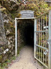 Garmisch-Partenkirchen, Germany - Nov 17 2022 : The entrance door leading through a cave to Partnachklamm Gorge, opening to stunning rocky cliffs and the sound of rushing water in Garmisch-Partenkirch