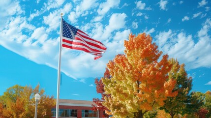 American Flag Waving Against a Blue Sky with Autumn Trees