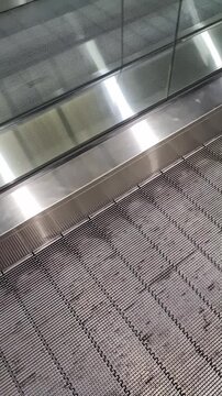 View of the shiny silver conveyor belt for pedestrians at an airport.