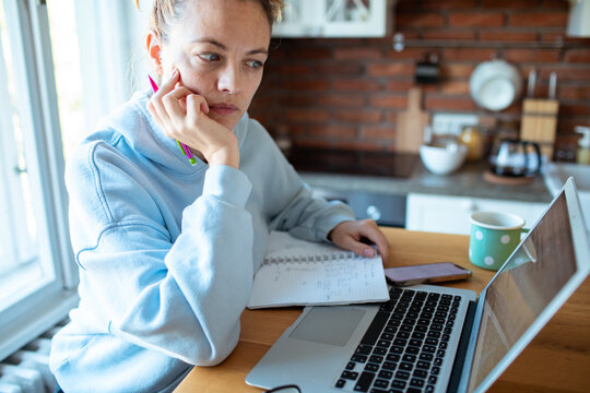 Young woman working on laptop at home