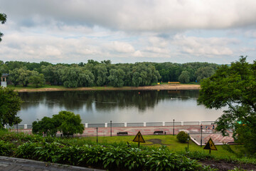 The Sozh River embankment on a cloudy summer evening. View from the Gomel Palace and Park Ensemble.