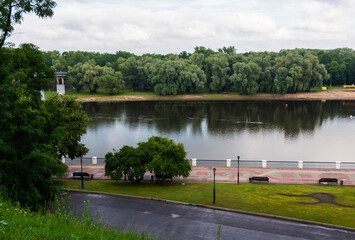 The Sozh River embankment on a cloudy summer evening. View from the Gomel Palace and Park Ensemble.