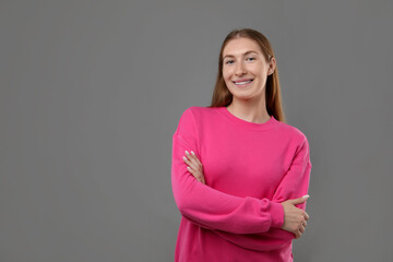 Obraz premium Smiling girl with braces on grey background, space for text