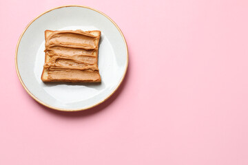 Delicious sandwich with peanut butter on pink table, top view. Space for text