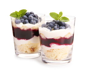 Tasty trifle dessert. Sponge cake, blueberries, jam and whipped cream in glasses isolated on white