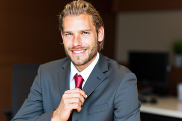Portrait of confident businessman smiling in office setting
