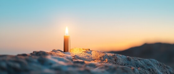  A lit candle atop a snowy mound under bright midday skies, framed by a clear blue backdrop