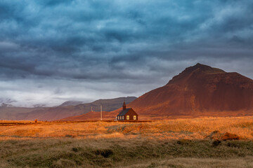 Black wooden church of Budor at sunrise
