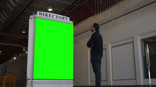 Mall Filler - Man walks up to a green screen mall directory sign