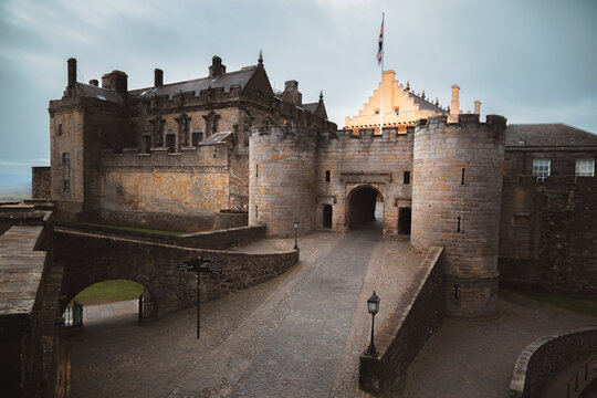 Atmospheric view of Stirling Castle, an iconic medieval fortress in Scotland with dramatic stone architecture and a moody entrance gate.
