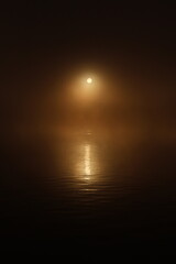 Sunrise Through Fog Over Water