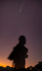 wallpaper with a background of starry sky and the shadow of a man.