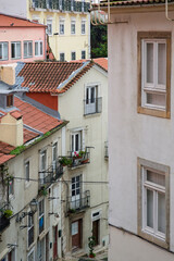 Naklejka premium Street perspective view with colorful traditional houses. Lisbon, Portugal. Colorful buildings of Lisbon historic center, Portugal. Street with colorful houses in Lisbon, Portugal.
