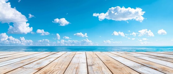  A wooden floor faces an ocean view under a blue sky dotted with white clouds