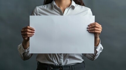 Woman is holding a blank piece of paper. Concept of emptiness or lack of content